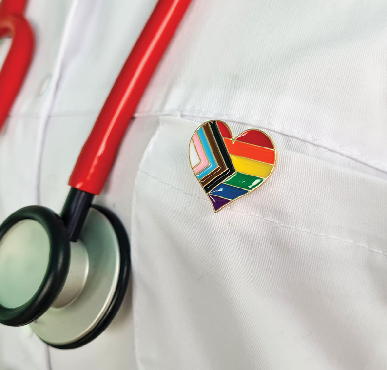 Veterinarian wearing a progress pride flag pin on white coat
