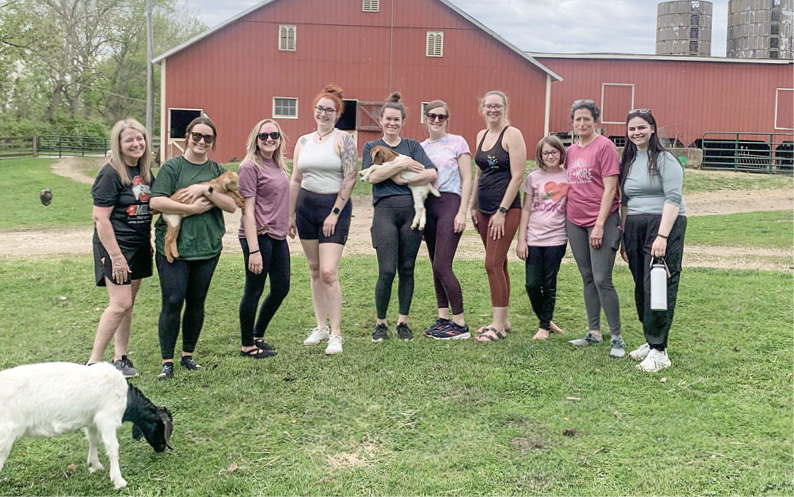 Group photo from a goat yoga team-building activity