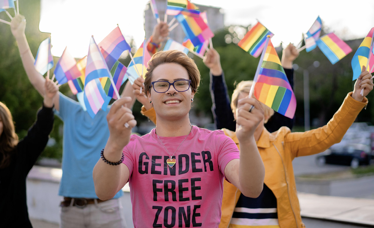 LGBTQ+ activist holding rainbow flags
