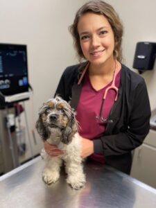 Veterinary technician Meagan Hembrough poses with a patient